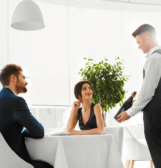 Romantic Dinner  Sommelier Presenting Best Wine To Happy Couple In Love  People Having Date In Gourmet Restaurant  Celebrating Anniversary Or Valentine's Day  Romance, Relationship  Alcoholic Drinks 