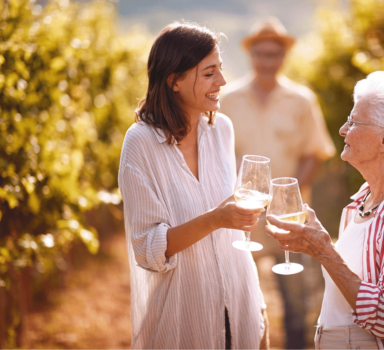 Smiling family in vineyard tasting wine 