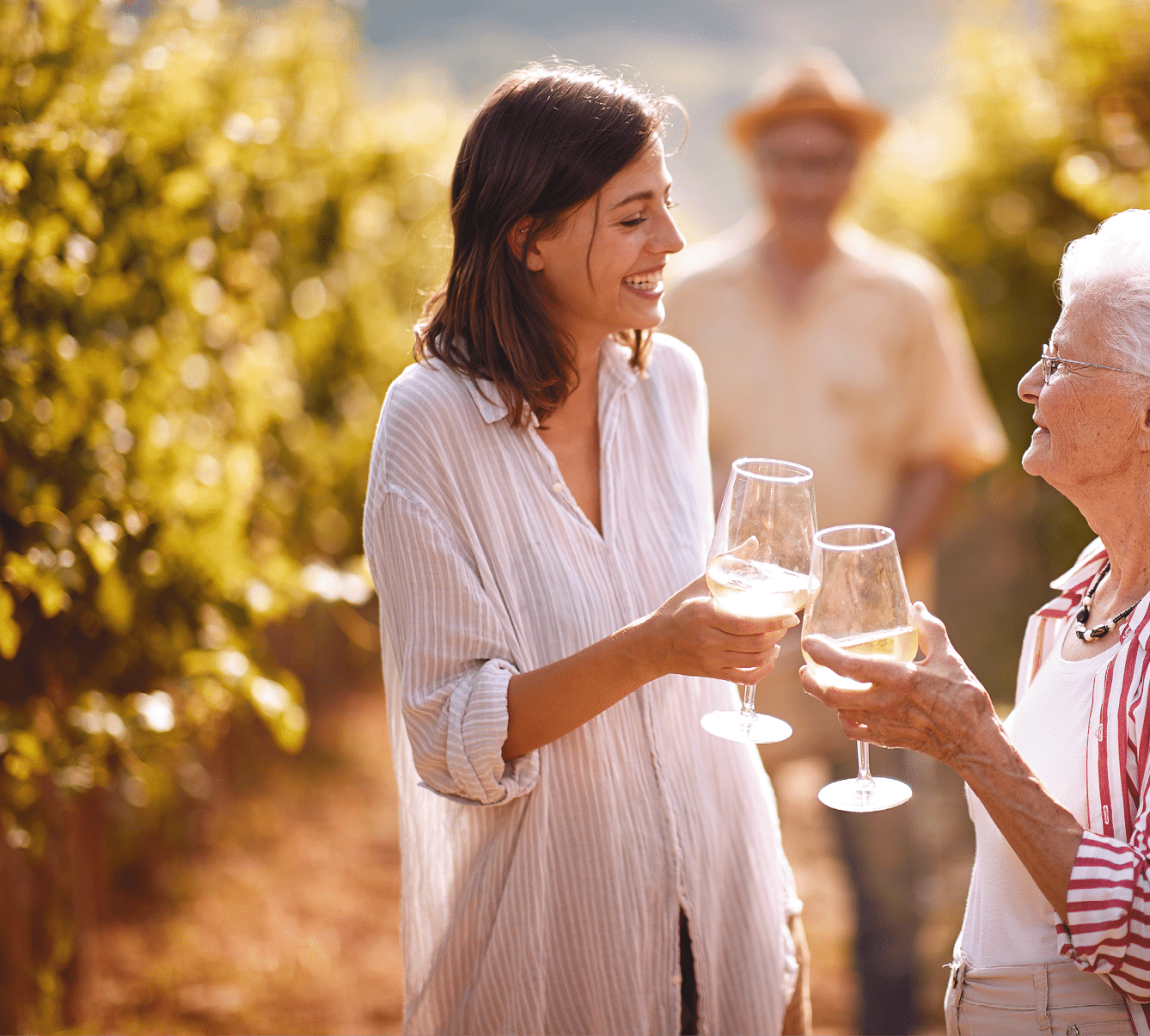 Smiling family in vineyard tasting wine 